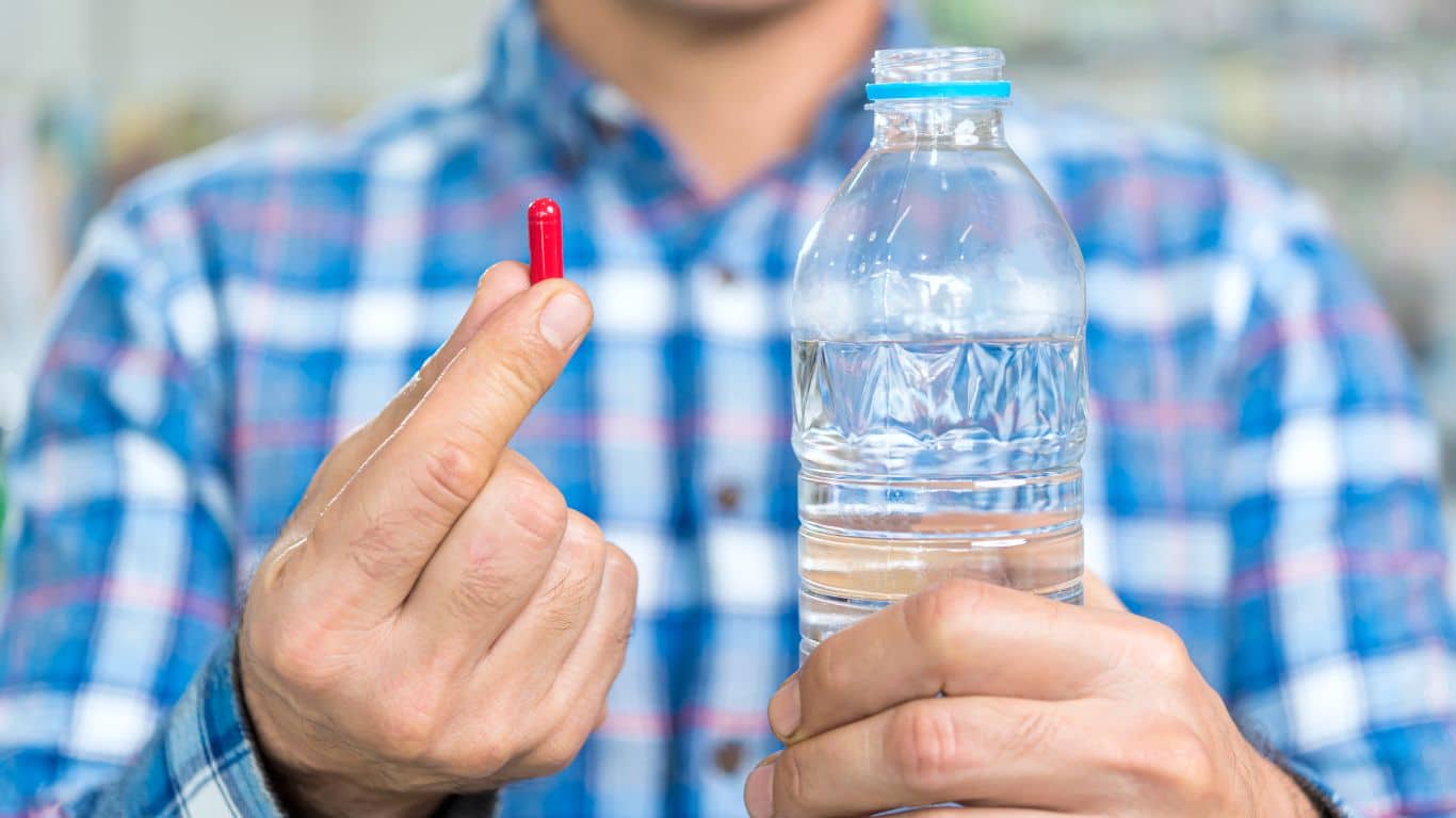 An image of a man taking supplements