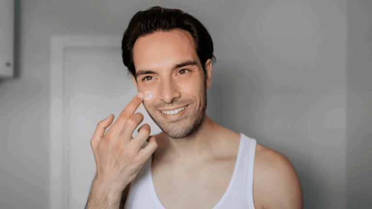 An image of a man applying a facial cream on his face