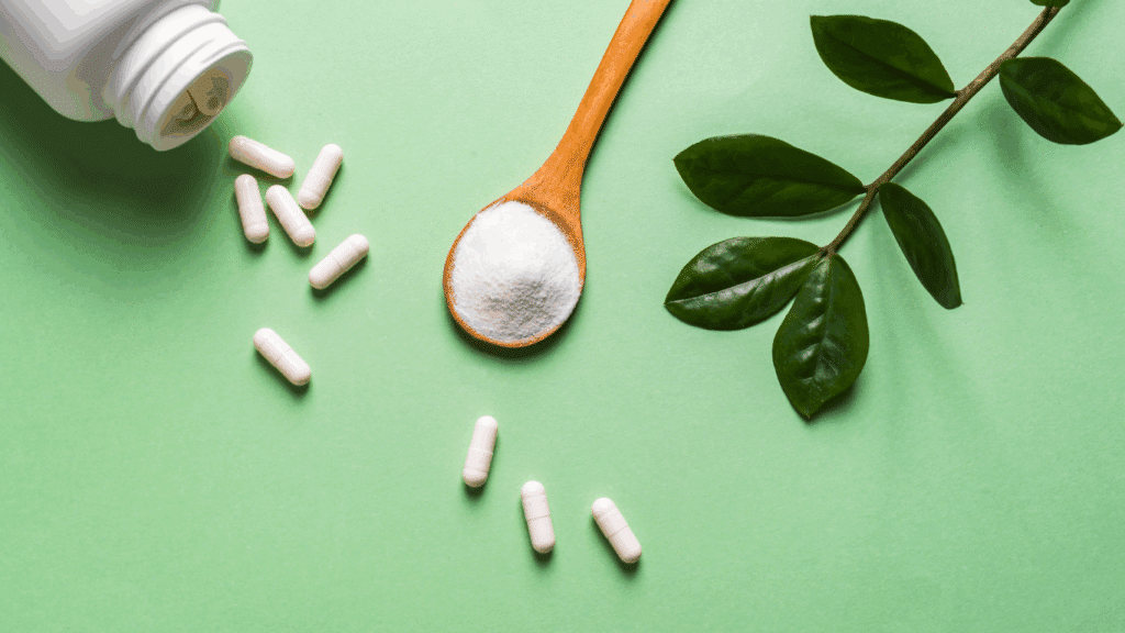 An image of supplements spilling out of a canister against a green background.