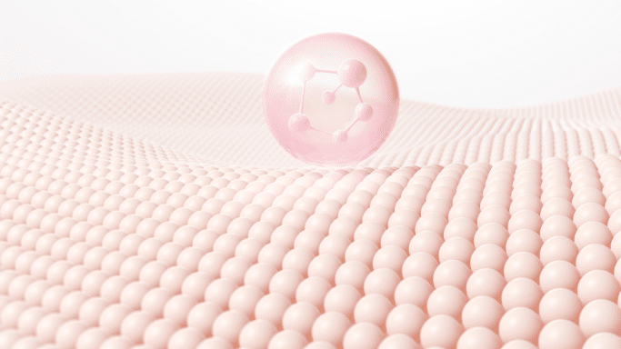 An abstract 3D digital illustration depicting skin cell structure. A single, floating pink translucent bubble containing a white chemical molecule diagram sits above an undulating terrain made of hundreds of tiny, neatly packed light pink spheres, symbolizing skin layers or collagen absorption.