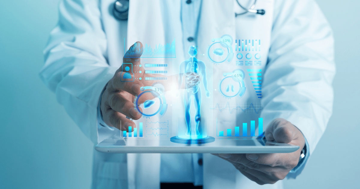 A doctor in a white coat holds a digital tablet from which a bright blue, futuristic hologram projects upward. The holographic interface displays a full-body human anatomy model surrounded by various medical data charts, graphs, and lung and liver health icons.