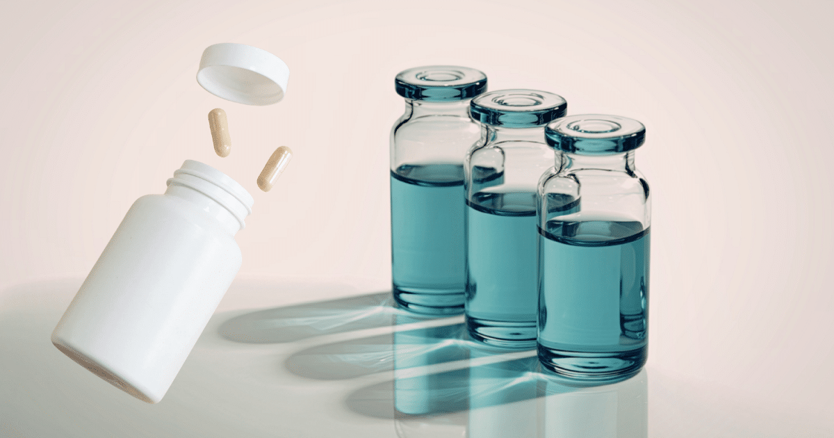 A 3D rendering of a white medicine bottle floating at an angle on the left, with its cap detached and two beige capsules spilling out. On the right, three clear glass medical vials containing a blue liquid stand in a row, casting strong shadows on a light surface.
