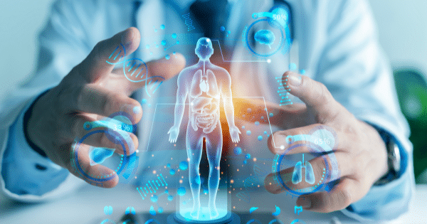 A doctor’s hands interacting with a glowing blue futuristic digital hologram of a human body.
