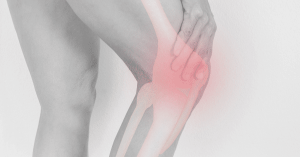 A black-and-white image focusing on a person's knee, with a transparent anatomical overlay showing the knee bones. A glowing red highlight indicates pain or inflammation in the joint.