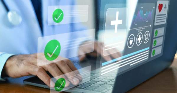 Close-up on the hands of a doctor typing on a laptop, overlaid with a transparent digital interface displaying medical data graphs, checkmarks, and patient checklist items.