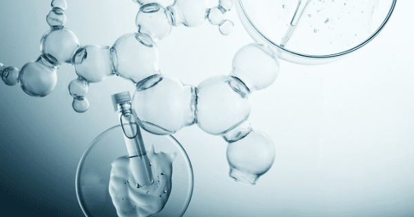 Glass laboratory molecular structures overlaid with petri dishes containing liquid serums and skincare gels against a light blue background.