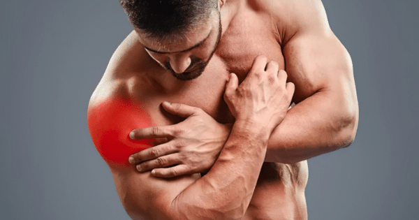 A shirtless, muscular man clutching his shoulder, with glowing red highlight on the shoulder area indicating pain or injury.